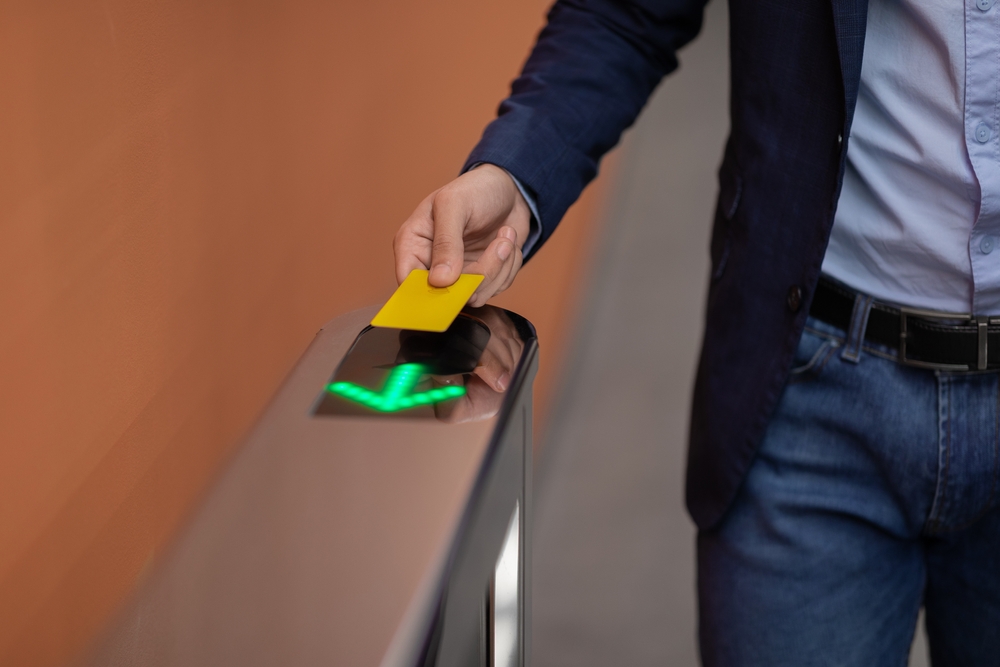 Unrecognizable,Man,In,Formal,Outfit,Holding,Electronic,Entrance,Gate,Card,